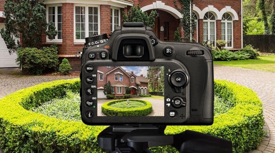 A camera taking real estate photo of a property from outside