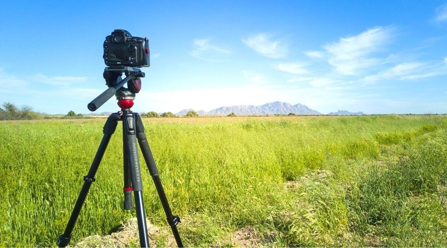 Camera mounted on Tripod shooting landscape photo